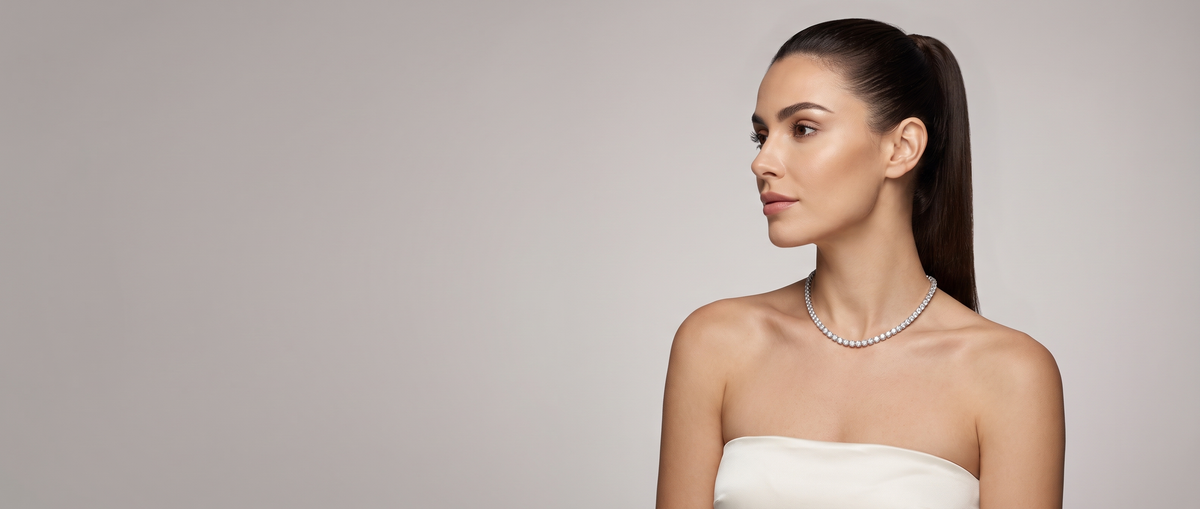 Model wearing the Ellevesa round-cut tennis necklace